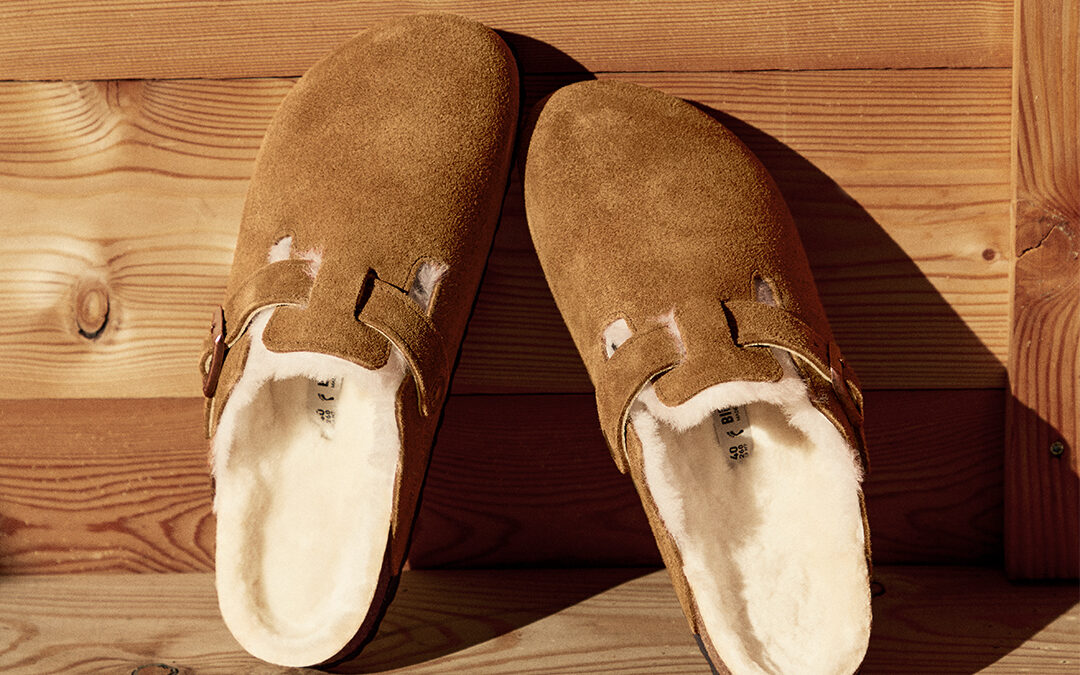 birkenstocks leaning against a wood wall