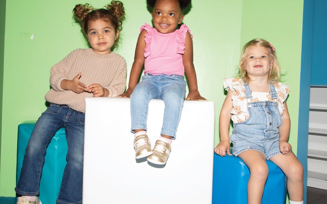 children sitting on blocks