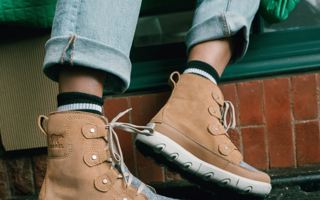 Sorel boots in front of brick