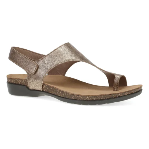 Dansko Women's Reece Sandal in bronze metallic leather, featuring an adjustable hook-and-loop strap, a cushioned EVA footbed, and a lightweight rubber outsole.