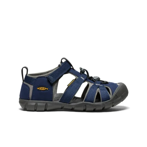 Keen Big Kid’s Seacamp II CNX Sandal with secure bungee lace, adjustable hook-and-loop strap, protective toe cap, and non-marking rubber outsole for traction.