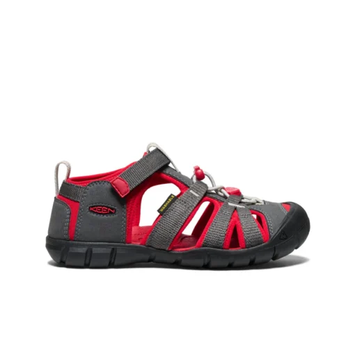 Keen Big Kid’s Seacamp II CNX Sandal with secure bungee lace, adjustable hook-and-loop strap, protective toe cap, and non-marking rubber outsole for traction.